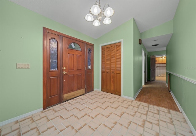 entrance foyer featuring a notable chandelier and lofted ceiling