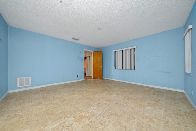 spare room featuring a textured ceiling