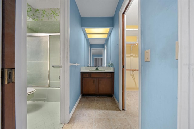 full bathroom featuring vanity, toilet, and bath / shower combo with glass door