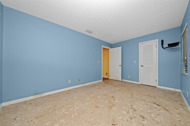 unfurnished bedroom with a textured ceiling