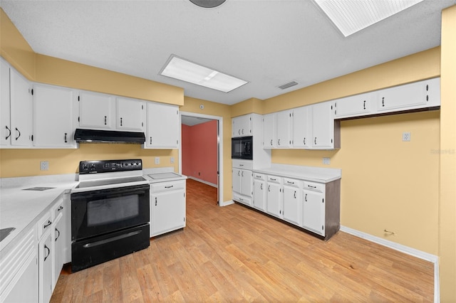 kitchen with white cabinetry, light hardwood / wood-style flooring, and black appliances