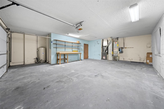 garage featuring heating unit, a garage door opener, and water heater