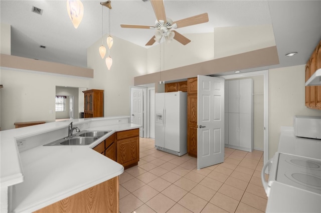 kitchen featuring light tile patterned floors, white appliances, ceiling fan, and sink