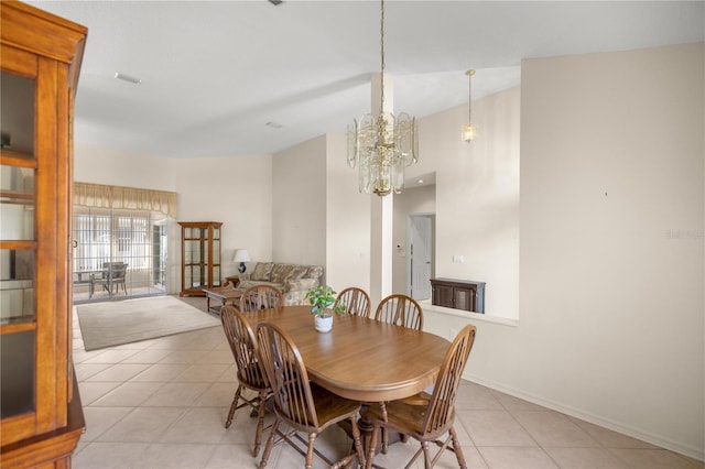 dining room featuring light tile patterned flooring and a chandelier