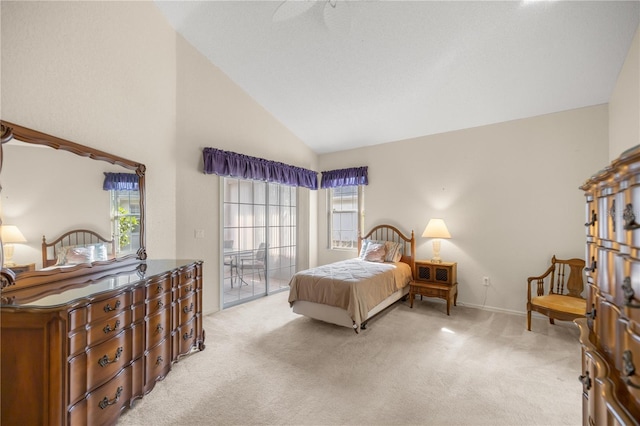 carpeted bedroom with access to outside, multiple windows, ceiling fan, and high vaulted ceiling