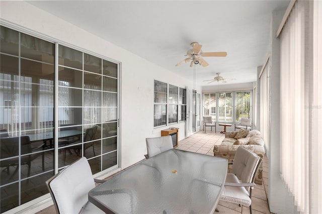 sunroom / solarium featuring ceiling fan