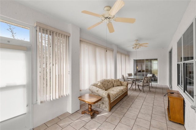 sunroom featuring ceiling fan