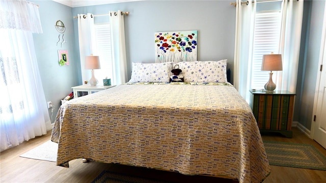 bedroom featuring light hardwood / wood-style flooring and multiple windows