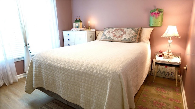 bedroom with hardwood / wood-style flooring