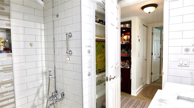 bathroom featuring walk in shower and wood-type flooring