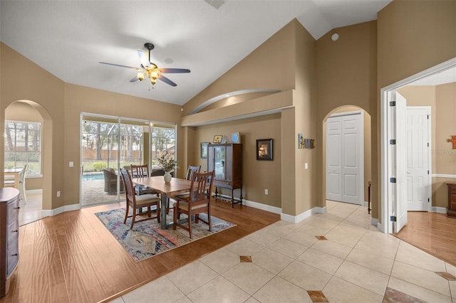 dining room featuring light tile patterned floors, vaulted ceiling, and ceiling fan