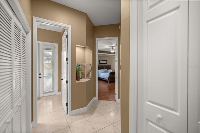 hall featuring light tile patterned floors