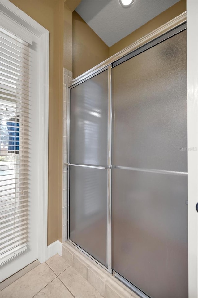 bathroom featuring tile patterned flooring and a shower with door