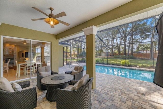 view of pool featuring a patio area, ceiling fan, and glass enclosure