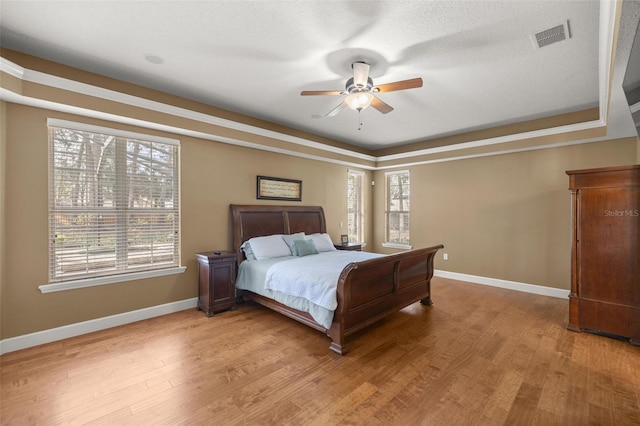 bedroom with ceiling fan and light wood-type flooring