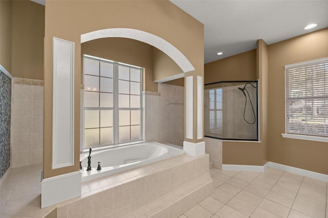 bathroom featuring plus walk in shower and tile patterned flooring