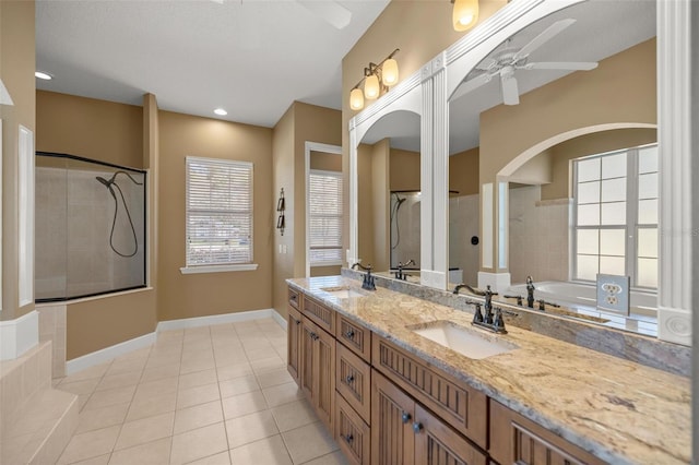 bathroom with shower with separate bathtub, vanity, tile patterned floors, and ceiling fan