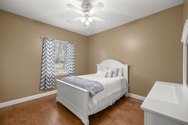 bedroom with ceiling fan and hardwood / wood-style flooring