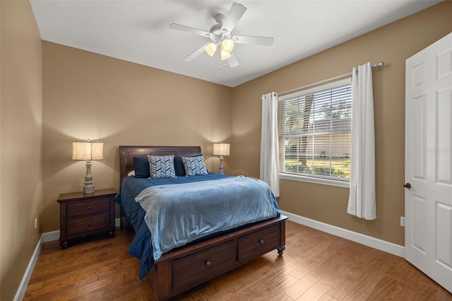 bedroom with ceiling fan and wood-type flooring