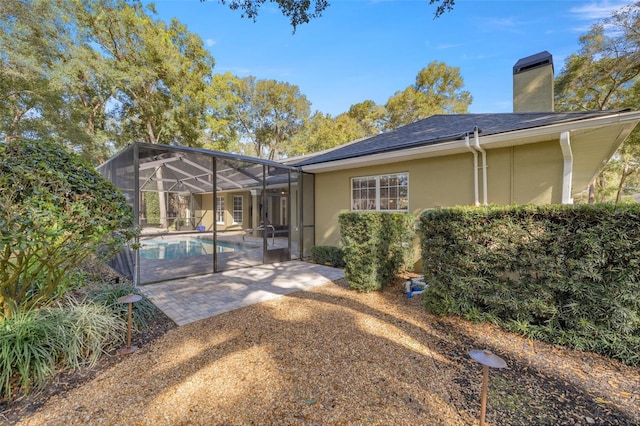 rear view of house featuring a lanai and a patio