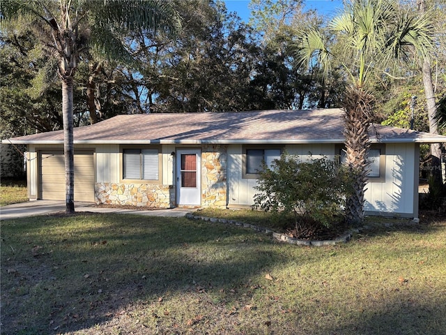 single story home featuring a front lawn and a garage