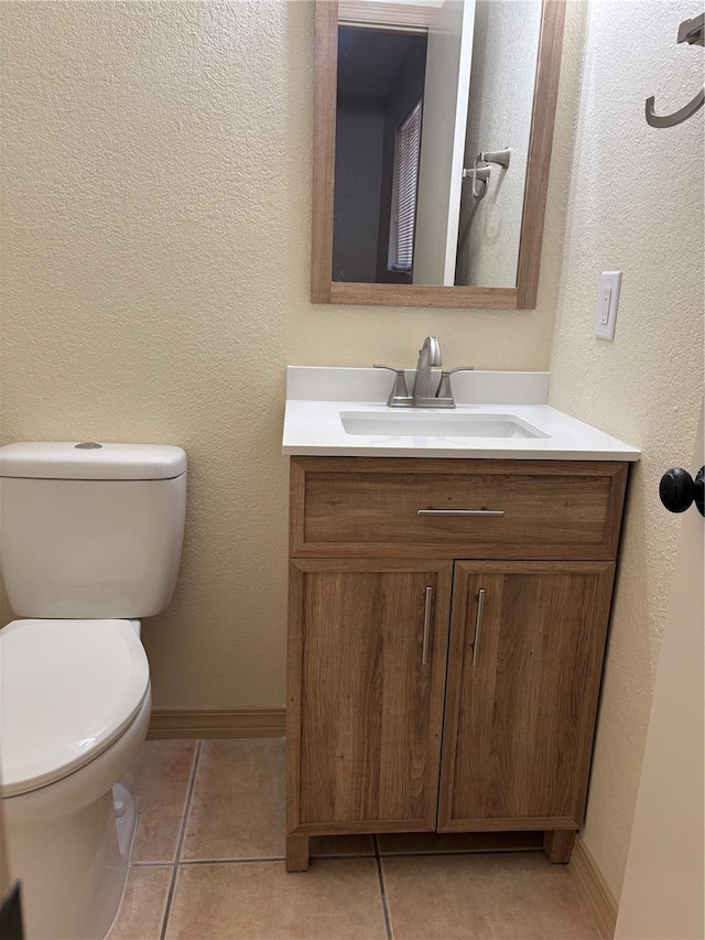 bathroom featuring toilet, vanity, and tile patterned floors