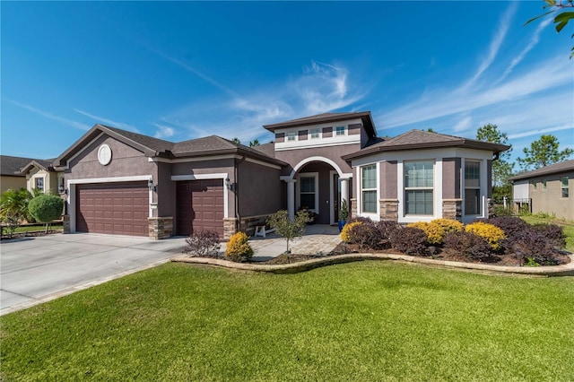 view of front of property featuring a front yard and a garage