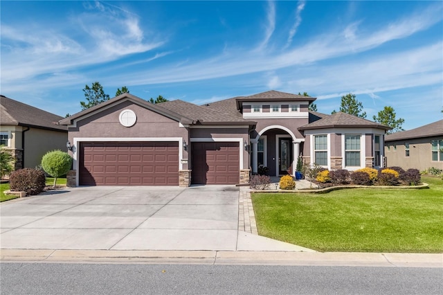 view of front of home with a garage and a front lawn