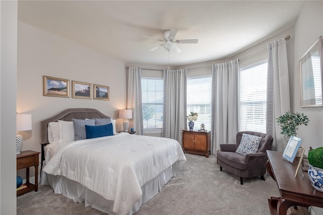 bedroom with ceiling fan and light carpet