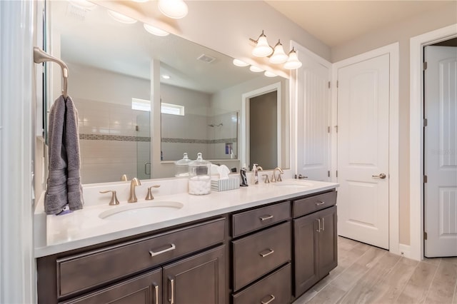 bathroom featuring vanity and an enclosed shower