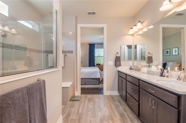 bathroom featuring a shower and vanity