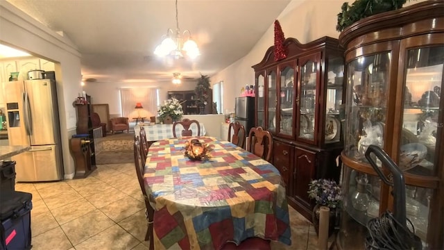 dining space featuring a notable chandelier and light tile patterned flooring