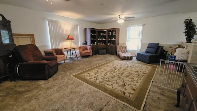 living area with ceiling fan and carpet floors