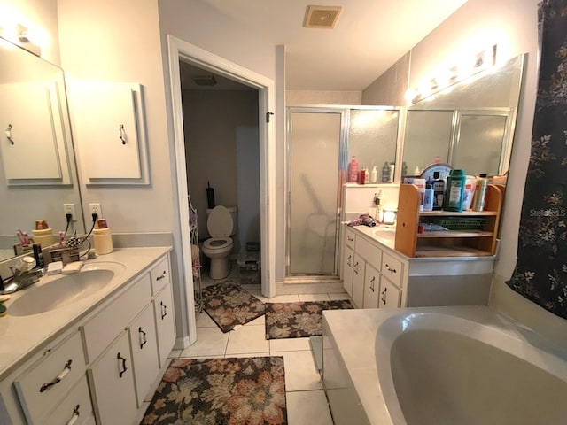 full bathroom featuring two vanities, visible vents, a stall shower, a sink, and tile patterned floors