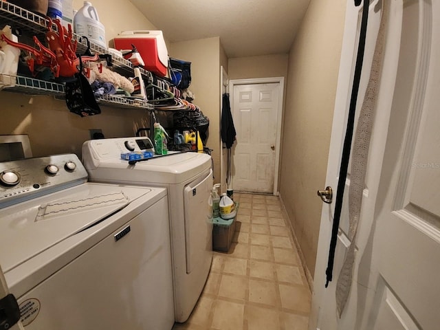 laundry area with washing machine and dryer, laundry area, and baseboards