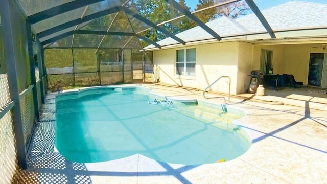 outdoor pool featuring a lanai and a patio area