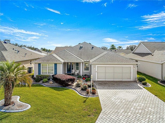 single story home with a garage and a front lawn