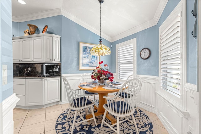 dining space featuring crown molding and light tile patterned floors