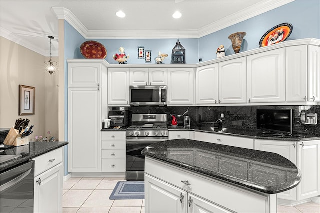 kitchen with stainless steel appliances, white cabinetry, tasteful backsplash, and light tile patterned flooring