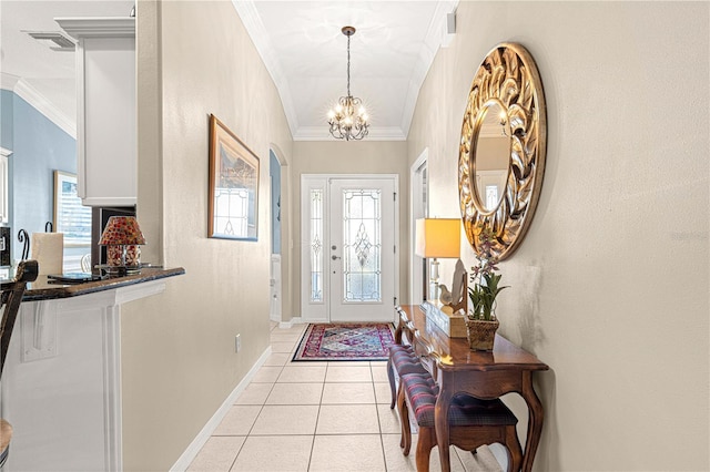 entryway featuring plenty of natural light, light tile patterned floors, a chandelier, and ornamental molding