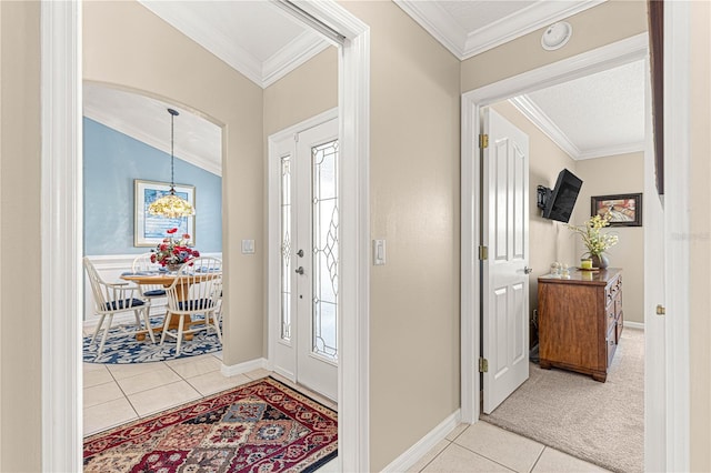 tiled foyer featuring vaulted ceiling, a wealth of natural light, and crown molding