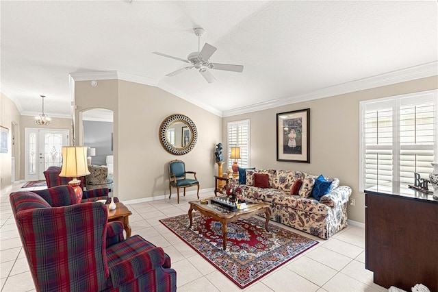 living room featuring light tile patterned floors, ceiling fan with notable chandelier, vaulted ceiling, and plenty of natural light