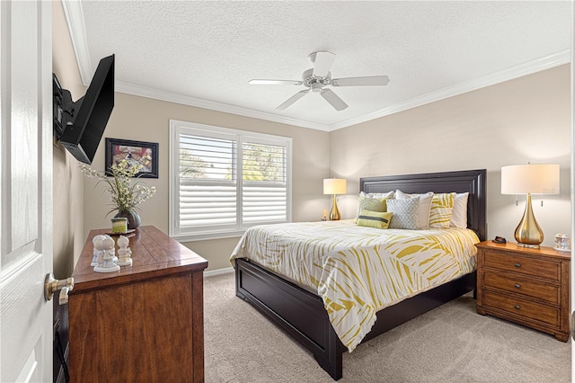 carpeted bedroom with a textured ceiling, ceiling fan, and ornamental molding