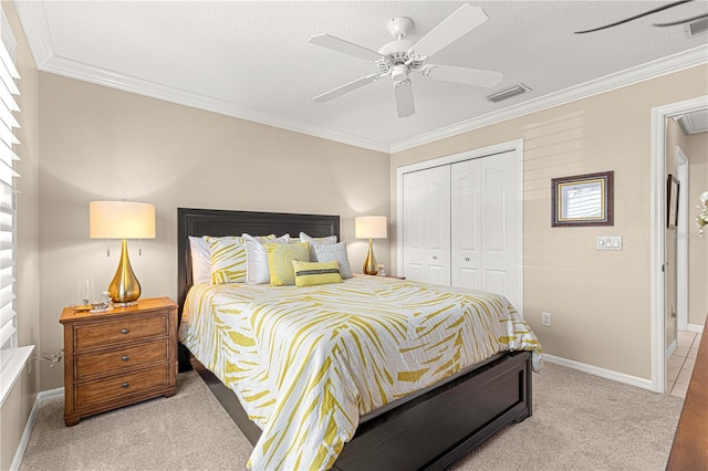 bedroom featuring ceiling fan, light colored carpet, ornamental molding, and a closet