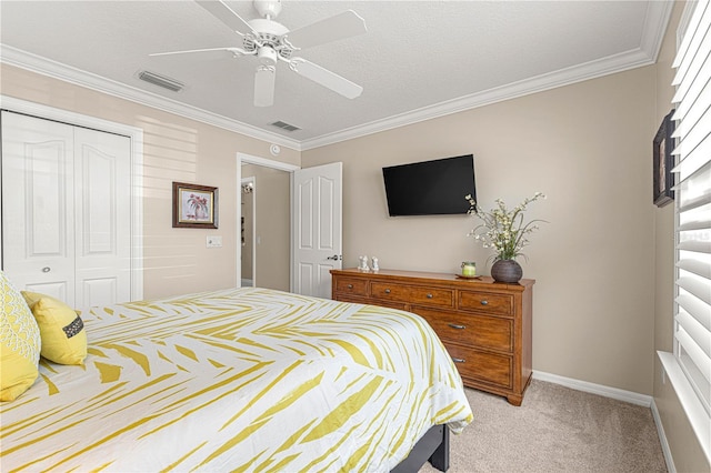 bedroom with ceiling fan, a closet, light carpet, and ornamental molding