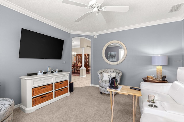 living room with ceiling fan, light colored carpet, a textured ceiling, and ornamental molding