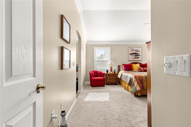 carpeted bedroom featuring crown molding and a textured ceiling