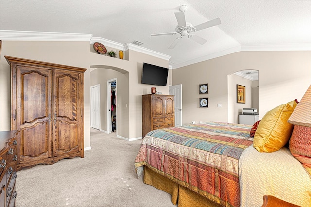 bedroom featuring ceiling fan, light colored carpet, a textured ceiling, vaulted ceiling, and a closet