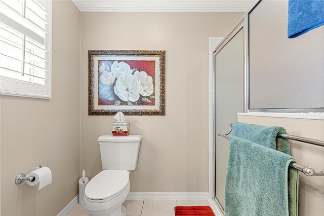 bathroom with tile patterned flooring, toilet, a shower with door, and ornamental molding