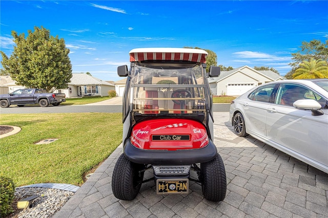 view of parking with a yard